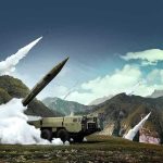 N.Korea Touts New Weapons System Described as Hypersonic mobile missile launcher firing in mountain landscape