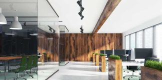 Modern open-plan office with wood accents and glass meeting room