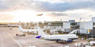 Airport Chaos: Passenger Hijacks Luggage Tug Airplanes at airport gates during sunset with ground vehicles and jet bridges