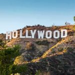 Hollywood Cage Match Erupts Over Mega Merger Hollywood Sign on a sunlit hillside