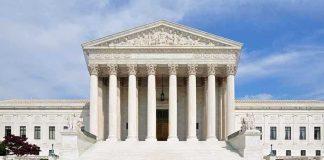 Alito Announcement Sparks Retirement Frenzy Front view of the Supreme Court building with large columns and steps under a blue sky