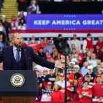 Trump Vows to Return Stolen Dem Money Back to Americans! Crowd at a political rally with a speaker at a podium; Stephen Paea, Curtis Lofton, Walter Jones, John Sullivan, and Colin David Jones present