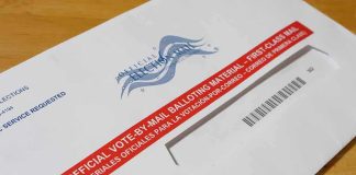 GOP Prepares for Election-Day Warfare: Lawyers Ready to Pounce Mail-in ballot envelope with red label on wooden table