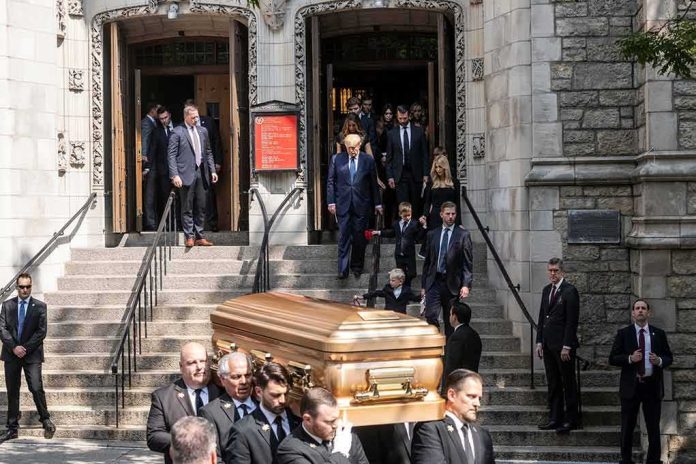 shutterstock_2180696039 Pallbearers carry a casket down church steps