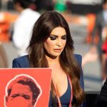 Kimberly Guilfoyle walking outdoors among a crowd