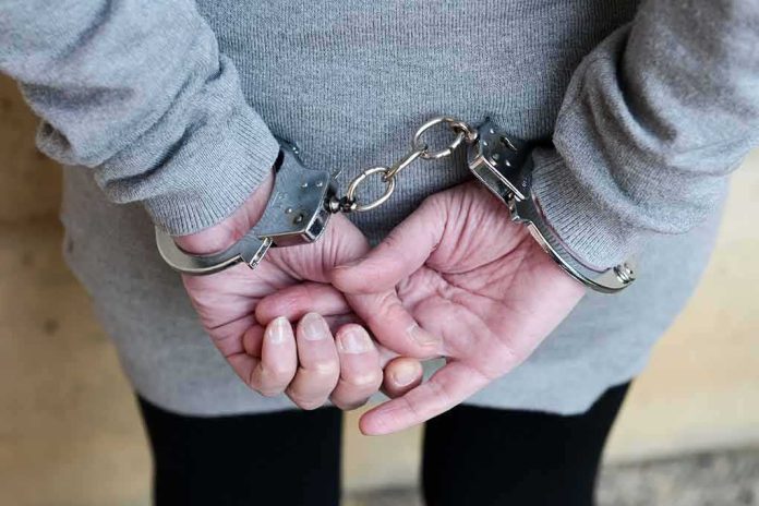 shutterstock_341510732 person in handcuffs with hands behind back