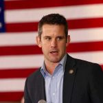 Disgraced RINO Bets On His Own Pardon man speaking in front of a large American flag