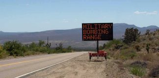 Trump Revives Forgotten Weapons Testing Program Portable electronic road sign on desert highway shoulder
