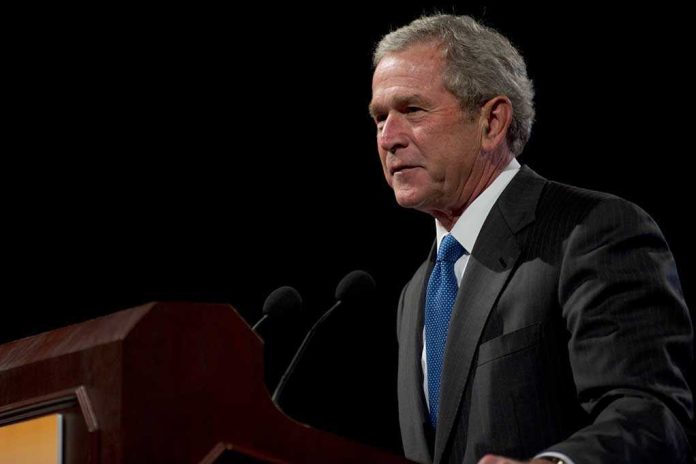 George W. Bush speaking at a podium with microphones
